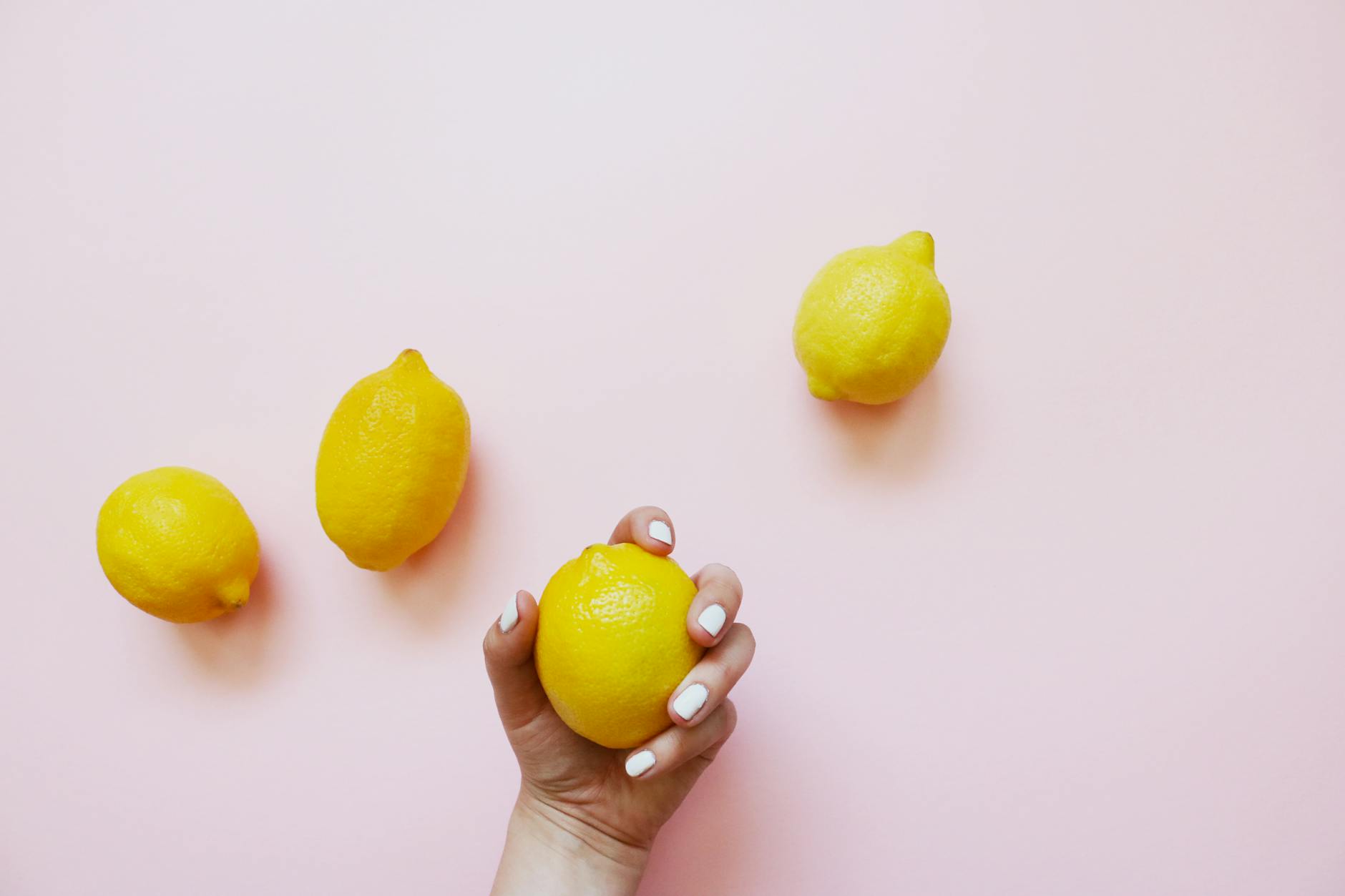 Hand holding an orange vibrator against a purple backdrop, representing sensual recovery tools