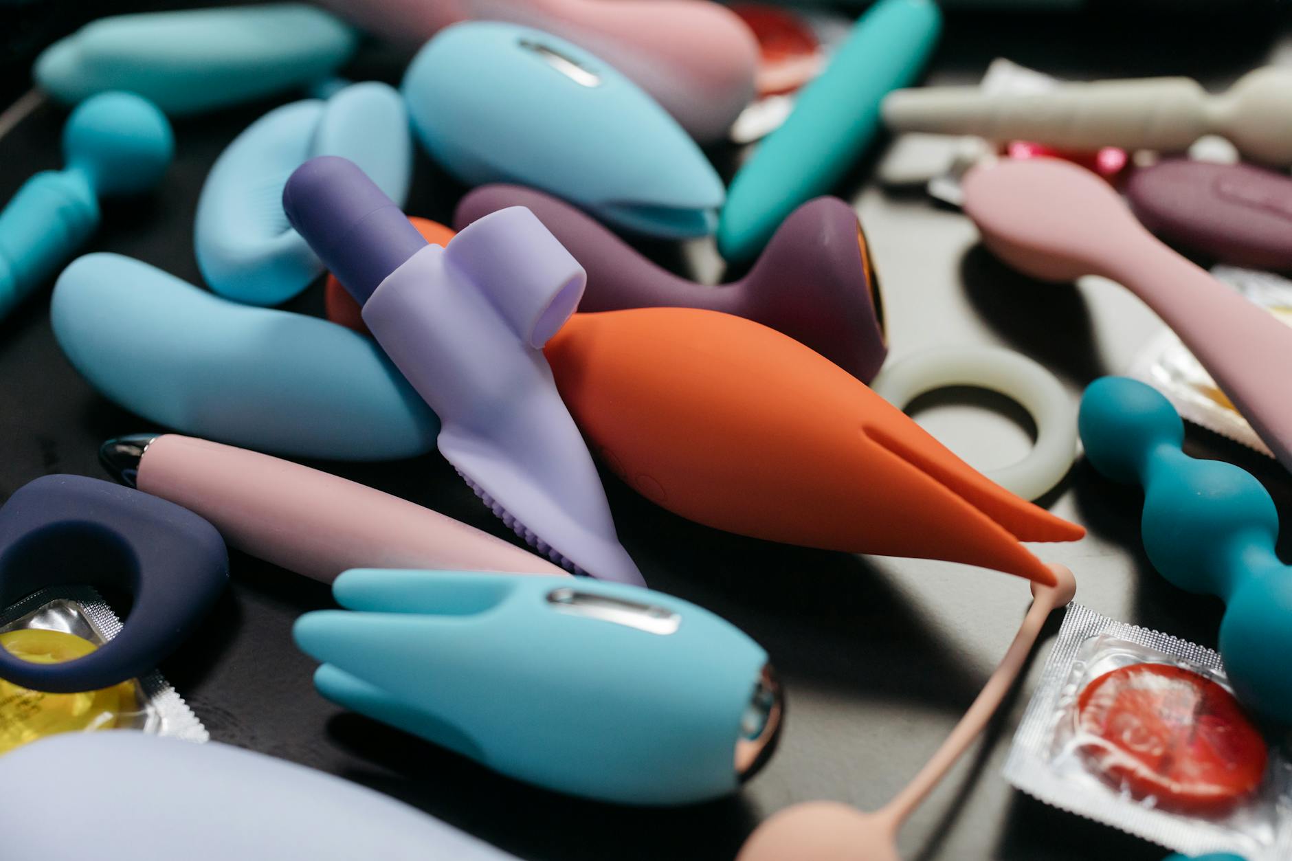An array of vibrant adult toys including lemon clitoral vibrators and other pleasure devices in a close-up view.