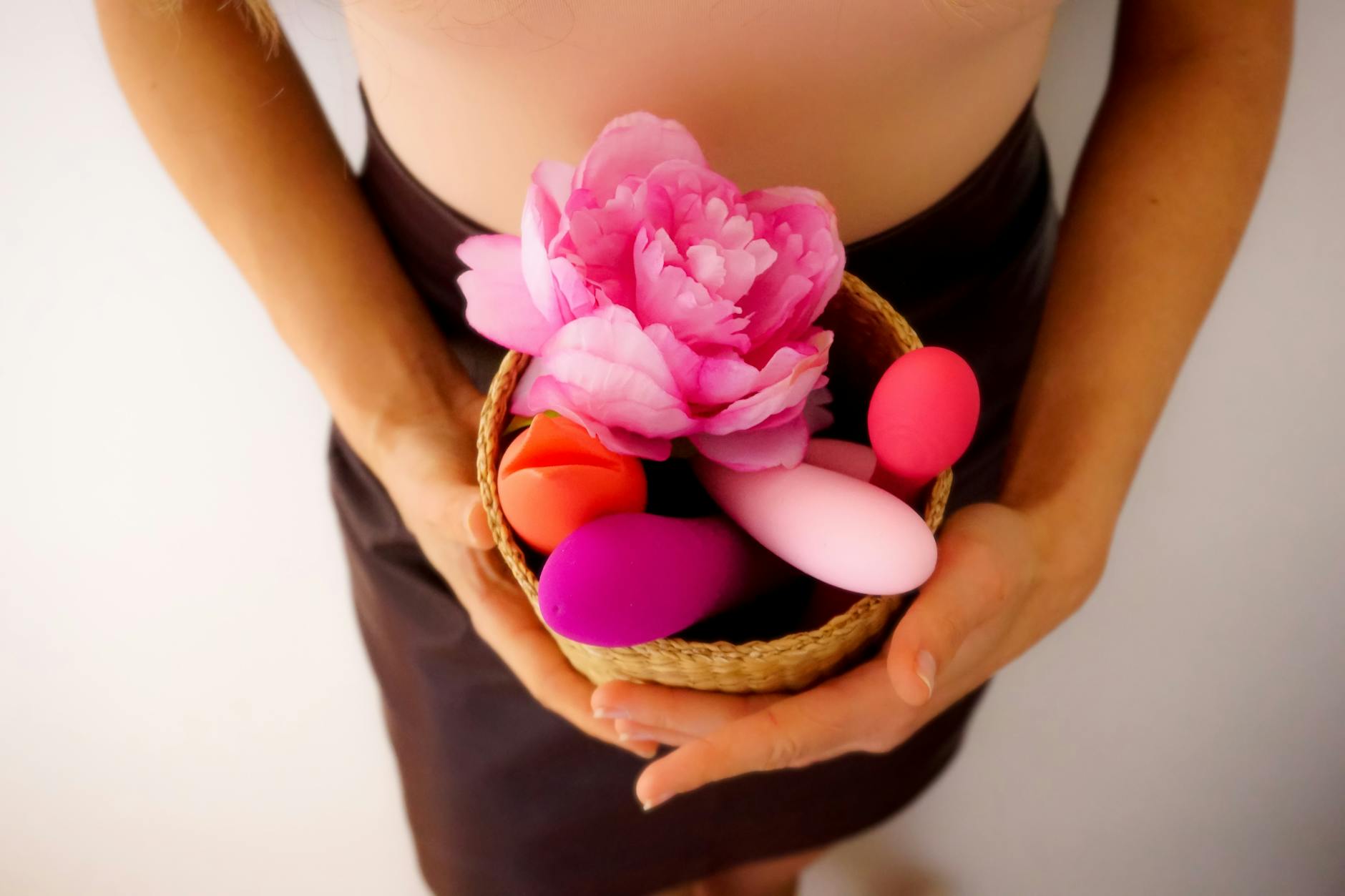 A basket of colorful vibrators and intimate wellness products